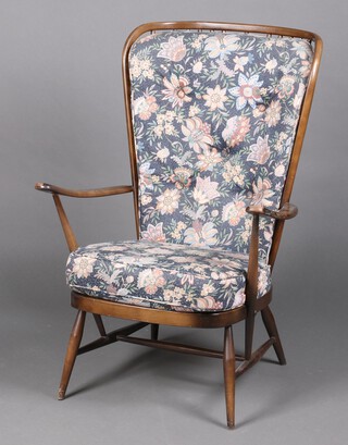 An Ercol dark elm and beech stick and rail back armchair 106cm h x 74cm w x 53cm d 