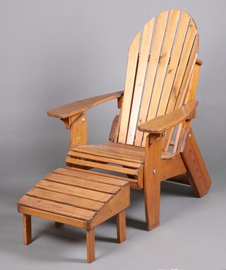 An "Adirondack" slatted folding hardwood garden armchair  113cm h x 74cm w x 70cm d together with matching stool 