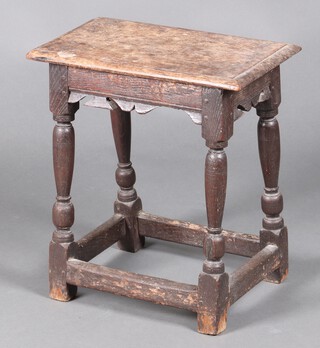 An 18th Century rectangular oak joined stool with carved apron, raised on turned and block supports with box stretcher 50cm h x 46cm w x 27cm d 