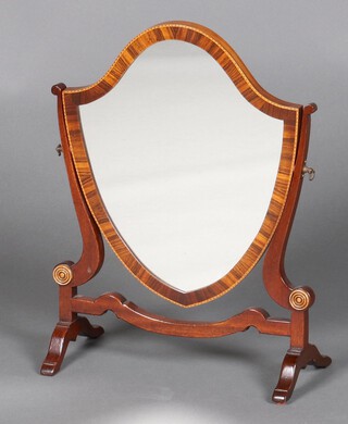 A Georgian style shield shaped dressing table mirror contained in a cross banded mahogany swing frame 46cm h x 35cm w x 16cm d 