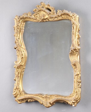 A shaped plate wall mirror contained in a gilt plaster frame 22cm x 38cm 