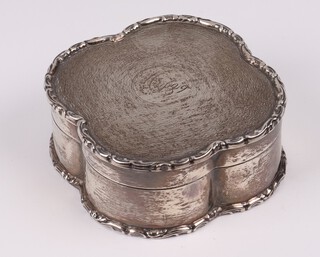 A shaped silver box with engine turned decoration and hinged lid marked May 1919, London 1918, by the Goldsmiths & Silversmiths Co. 7cm, 84 grams 