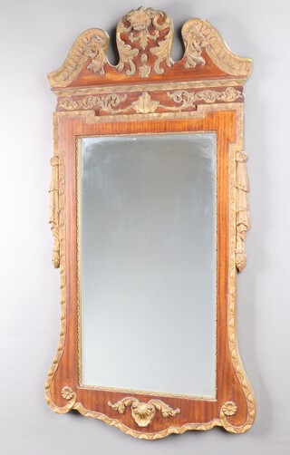 A 1920's rectangular Rococo style bevelled plate wall mirror contained in a walnut, gilt painted hardwood and plaster frame 106cm x 56cm 