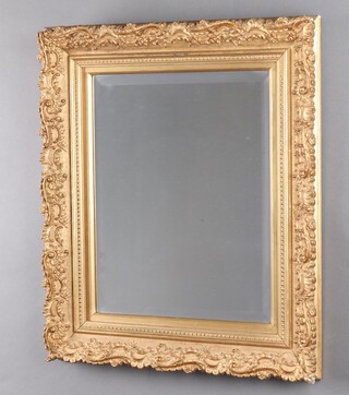 A rectangular bevelled plate wall mirror contained in a decorative gilt plaster frame 63cm x 43cm  