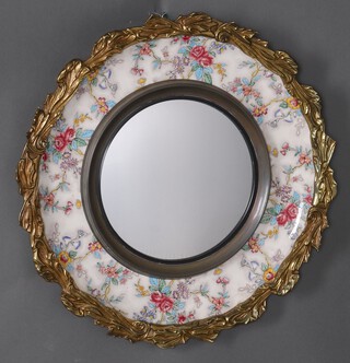 A circular convex plate mirror contained in a ceramic and gilt metal frame, the reverse marked Artmaster England Bilston Staffs 48cm diam. 