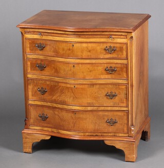 A Georgian style crossbanded and figured walnut chest of serpentine outline fitted a brushing slide above 4 long drawers 80cm h x 70cm w x 48cm d 