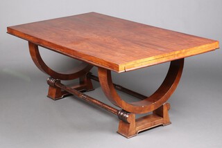 A 1930's Continental Art Deco rosewood dining table, raised on U shaped supports with 2 extra extension leaves 74cm h x 100cm w x 180cm l x 270cm l when extended  