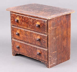 A brown painted pine apprentice chest of 3 drawers with Bakelite handles 31cm h x 36cm w x 24cm d 
