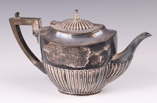 An Edwardian oval silver teapot with demi-reeded decoration Birmingham 1904 by Fenton Brothers Ltd., 581 grams 