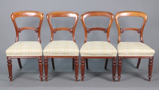 A set of 4 Victorian mahogany spoon back dining chairs with shaped mid rails and overstuffed seats, raised on turned and reeded supports 88cm h x 46cm w x 44cm d 