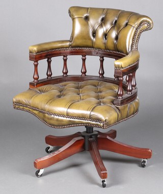 A reproduction Georgian mahogany revolving and reclining captains chair, upholstered in green buttoned leather 84cm h x 62cm w x 48cm 