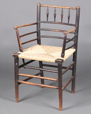 William Morris, an ebonised elm Sussex stick and rail back chair with later woven rush seat 85cm h x 52cm w x 43cm d 