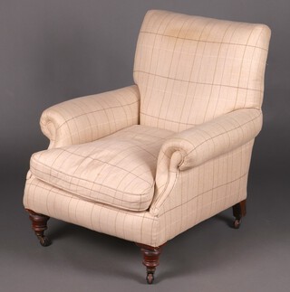 A Howard style armchair upholstered in white chequered material, raised on turned supports 88cm h x 78cm w x 81cm d 