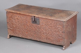 An early 17th Century elm boarded, slab-ended coffer, the front board decorated low relief foliate strapwork and fitted a square lock plate, the interior fitted a candle box with nail hinge 40cm h x 93cm w x 36cm d. Similar strapwork Cesinsk
