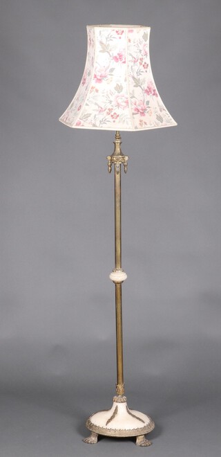 A 1920's gilt metal and onyx standard lamp on a circular base with paw feet 130cm h 