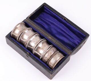 Four Victorian matched silver napkin rings of waisted form Birmingham 1886  (x2) and 1898 (x2) and 2 other napkin rings, cased, 57 grams  