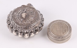 A Continental embossed silver scallop shaped pill box with hinged lid, import marks, together with a 925 silver jar and cover with parcel gilt interior and engine turned decoration, gross weight 42 grams 