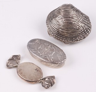 An oval silver trinket box the lid cast a Tudor Rose, London 1977, a 925 silver pill box in the form of a clam shell 4cm and 1 other in the form of a sweet 5cm, gross weight 42 grams 