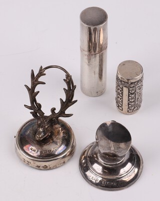 A silver place card holder in the form of a stags head Birmingham 1915, a plain silver place card holder on a circular base Birmingham 1934 (some dents to the base), a lipstick case Birmingham (marks rubbed), a Continental silver embossed ditto 3cm 
