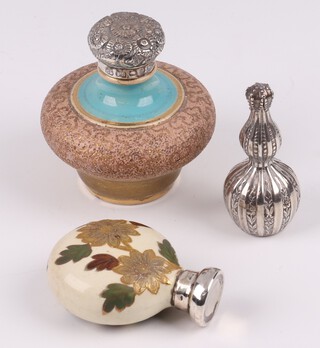 An embossed metal club shaped scent bottle 4.5cm, a Burslem China pottery scent bottle with silver lid, 1 other pottery scent bottle with silver lid 5cm 