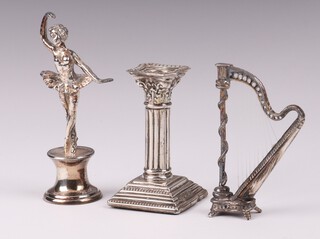 An Edwardian miniature silver candlestick with Corinthian column capital Birmingham 1905 by Boots Pure Drug Company 5cm (some dents to the base), a 925 silver model of a ballerina 8cm together with ditto harp 6cm, 42 grams 