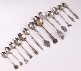 A Scottish silver Queens pattern teaspoon Edinburgh 1853 (dent to bowl and wear), a Georgian silver teaspoon with bright cut decoration (misshapen), 2 silver teaspoons, 41 grams and 9 other souvenir spoons 