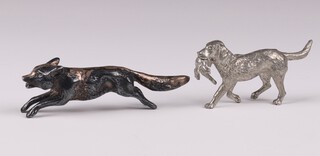A cast silver figure of a running fox Sheffield 1946 by James Dixon & Sons 52 grams, together with a cast metal figure of a retriever with pheasant 