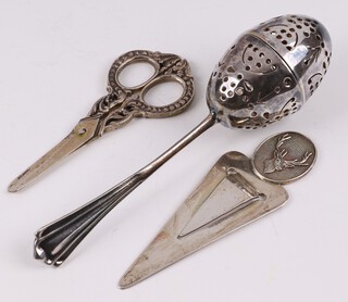 A silver bookmark decorated a stag Birmingham 1991, an Edwardian silver tea infuser Sheffield 1903 by Atkin Brothers 37 grams and a pair of miniature scissors marked 800 7cm 