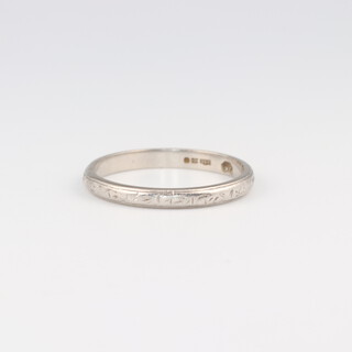 An engraved platinum wedding band marked Plat., size K, 2.3 grams 