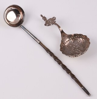 A Dutch embossed silver spoon decorated a classical figure, 28 grams together with a whale bone handled ladle 