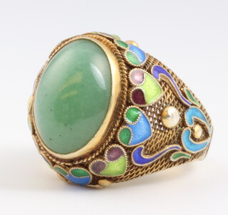 A Chinese silver gilt, jade and enamelled dress ring,  size G