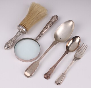 A Victorian silver fiddle and thread pattern table spoon, London 1840, a William IV silver fiddle pattern dessert fork London 1831, George III silver Queens pattern dessert spoon London 1885, 157 grams together with a Victorian silver handled table brush Birmingham 1891 and a silver handled magnifying glass 