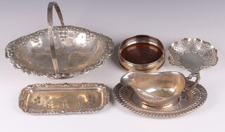 An embossed and pierced silver plated boat shaped cake basket with swing handle, a ditto snuffer tray, bottle coaster, pierced dish, sauce boat and stand and gravy boat stand 