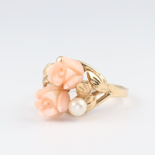 A 14ct yellow gold dress ring set a pearl and carved coral in the form of rose heads, size M 1/2, 3.3 grams