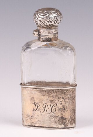 An Edwardian faceted glass and silver mounted hip flask with detachable cup, monogrammed, London 1904 
