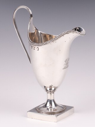 A Georgian silver helmet shaped cream jug with armorial decoration, London 1876,  101 grams 