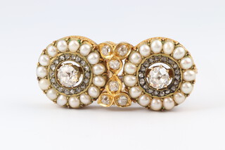 A 19th Century, yellow gold, testing as 22ct, bar brooch formed of 2 roundels, each set an old rose cut diamonds surrounded by pearls and with 6 smaller diamonds to the centre 