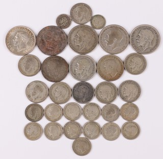 A collection of George V and VI pre 1947 silver coinage to include halfcrowns, florins, shillings, sixpences and threepences 185 grams
