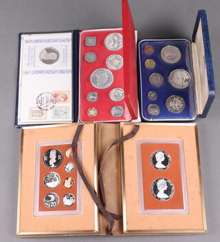 A 1974 Cook Islands 9 coin proof set contained in a leather display box and sleeve, a Commonwealth of the Bahamas proof set, a First National Coinage of Barbados proof set and a Medallic First day Cover of the 500th anniversary of Michelangelo's birth