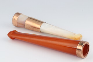 An "amber" cigar holder with 9ct yellow gold mount 6cm and a mother of pearl ditto 6.5cm 