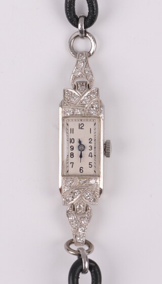 A lady's Art Deco platinum and diamond set cocktail wristwatch with rectangular dial and Arabic numerals, with leather strap 