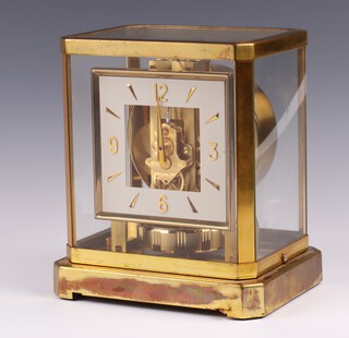 Jaeger Le Coultre, an Atmos clock no.114267,  circa 1960's, with rarer square white enamelled dial, Arabic numerals,  contained in a gilt brass case 24cm h x 20cm w x 16cm d  
