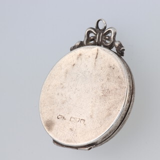 A silver double photograph locket  (some dents) 