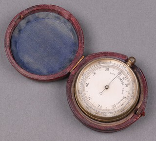 A pocket barometer with 4cm silvered dial contained in a gilt metal case and with leather outer case 