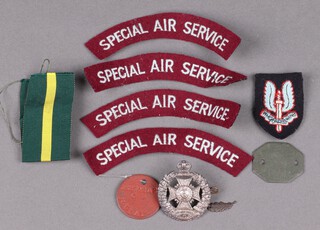 Four Special Air Service cloth shoulder titles, a Special Air Service copper beret badge, an Officer's Rifle Brigade Cap Badge, 2 dog tags marked 162702A2 J L Clay, a TD ribbon and a MID oak leaf 