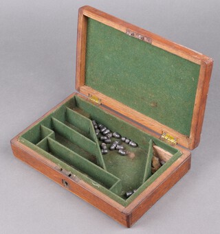 A 19th Century rectangular oak revolver box with fitted interior and various bullet heads 6cm h x 28cm w x 17cm d  
