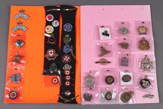 An On War Service 1914 lapel badge, a 1915 ditto, a Second World War discharge badge, an ARP badge and various civilian badges including St John's Ambulance, National Hospital Reserve, RPSCA 