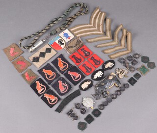 A collection of Second World War British Army cloth divisional badges including 7th Armoured Division and others, various pips and crowns 