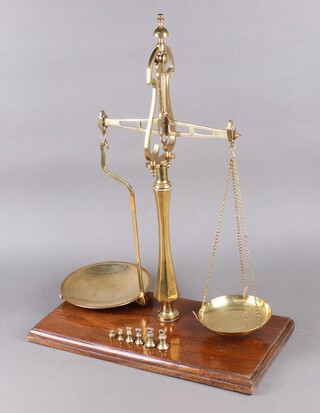 Librasco, a pair of 19th Century 2lb brass scales on a mahogany base, together with 6 brass bell weights - 2 marked 10, ounce (x2), 1 marked SA and a 1/2 ounce weight 