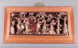 A rectangular Chinese carved and pierced hardwood gilt painted plaque depicting figures 23cm x 44cm  